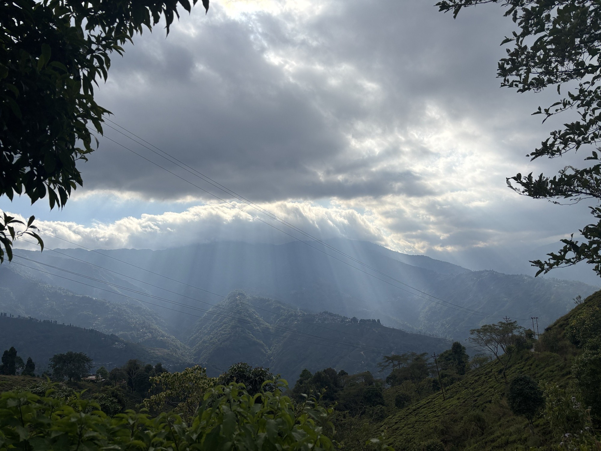 Sunlight breaking through clouds over the hills north of Siliguri